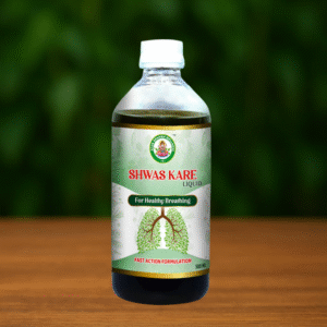 A 500 mL bottle of Ayur Brahma Advance Shwas Kare for healthy breathing rests on a wooden surface, featuring a green leafy lung illustration and a blurred green background.